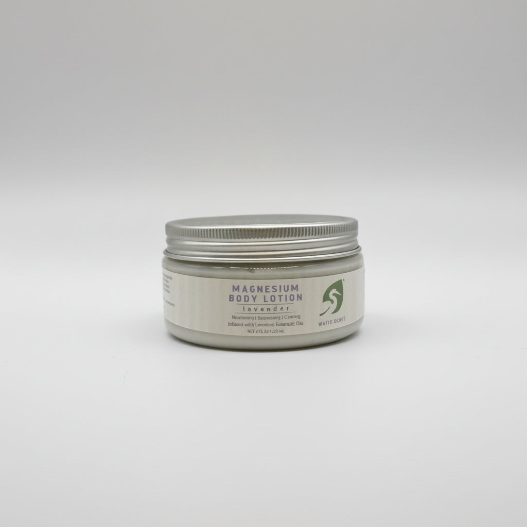 Jar of magnesium body scrub in a white container with a light background