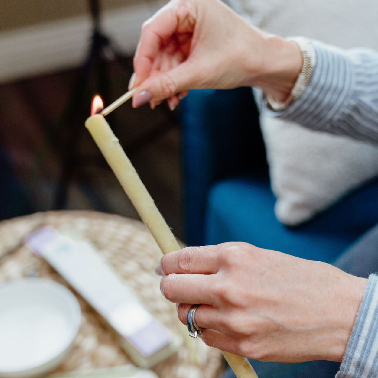 woman lighting ear candle with match and fire lifestyle image