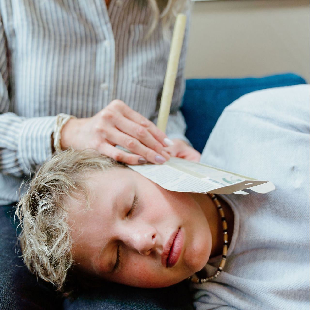 young boy being ear candled with white egrets ear candle all in one kit lifestyle image