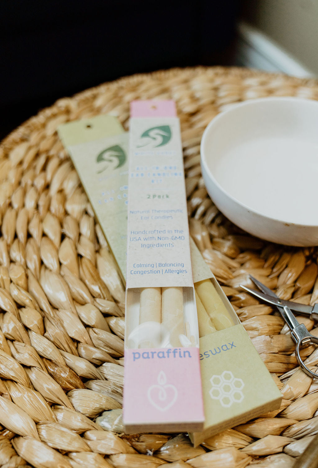 Ear candling kit components – beeswax ear cones, safety disk and matches.