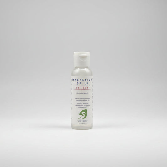 White bottle of Magnesium Daily Recover on a white surface