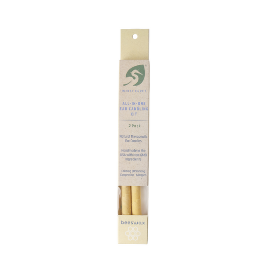 Beeswax ear candles in package on a white background