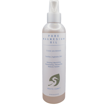 Bottle of Pure Magnesium Oil with a white label on a white background