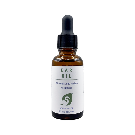 Bottle of ear oil with a dropper on a white background